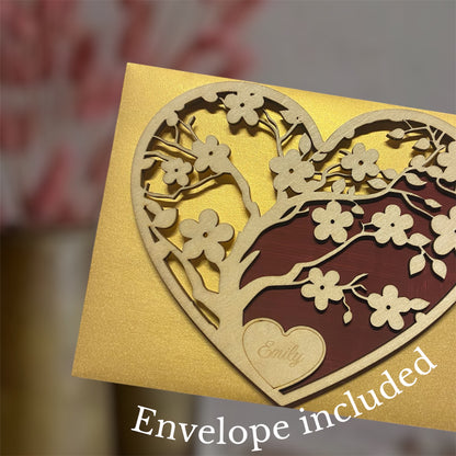 Wooden heart with cherry blossom cutouts on red background with golden envelope.